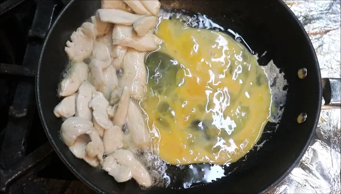 Scramble eggs: Add another tablespoon of oil and scramble the eggs in a figure-eight motion until mostly cooked.