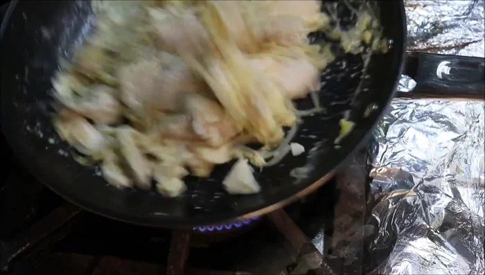 Add aromatics and sauce: Add garlic and the prepared sauce to the pan. Stir.