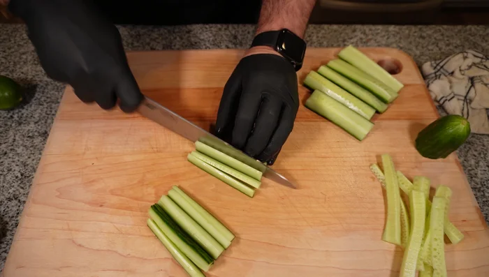 Cut cucumbers, bell peppers, carrots, and honey nuts into long, skinny strips.