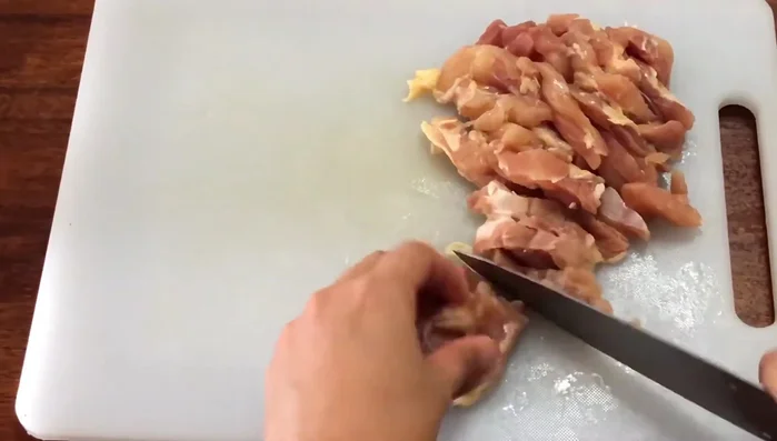 Cut chicken thigh into two pieces.