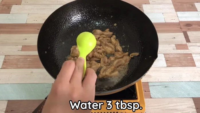 Add water and fry with medium heat until chicken is cooked.