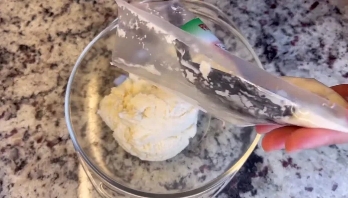 Pour thawed cassava into a mixing bowl.