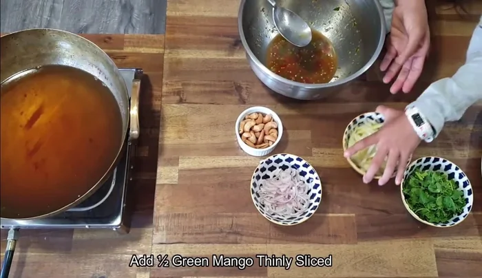Add green mango to the sauce and mix well.