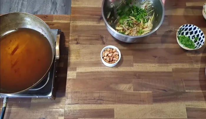 Add coriander and cashew nuts to the mango salad.