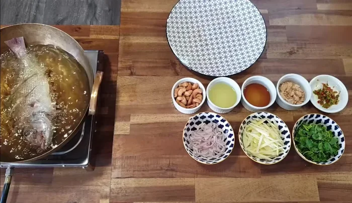 Deep fry the snapper until crispy and golden brown.