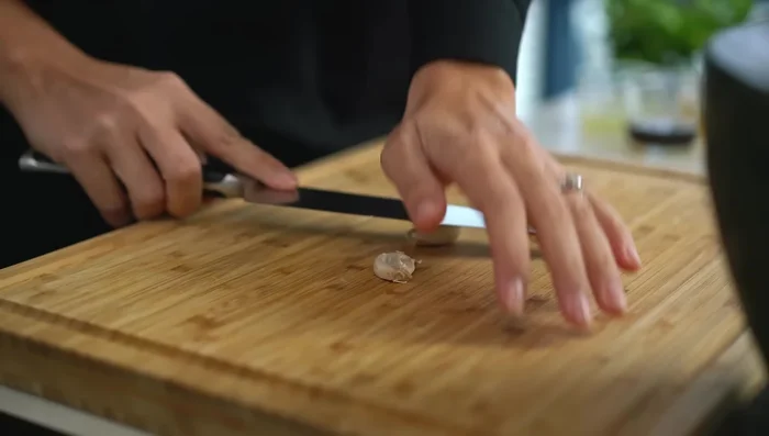 Prepare the sauce: Pound garlic, coriander root, salt, and chilies to a rough paste (or finely chop).