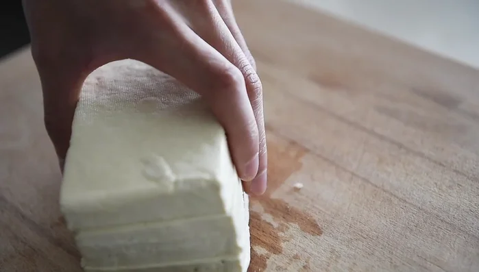 Preheat oven to 375°F. Slice tofu, season with salt and pepper, and bake on parchment paper for 25-30 minutes for crispy tofu.