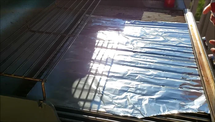 Spray the grill and place foil on it.