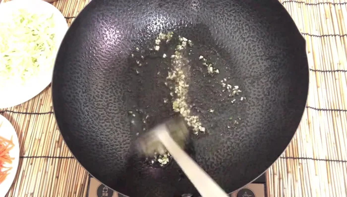 Add cabbage and fry until softened. Then add carrots and fry until tender.