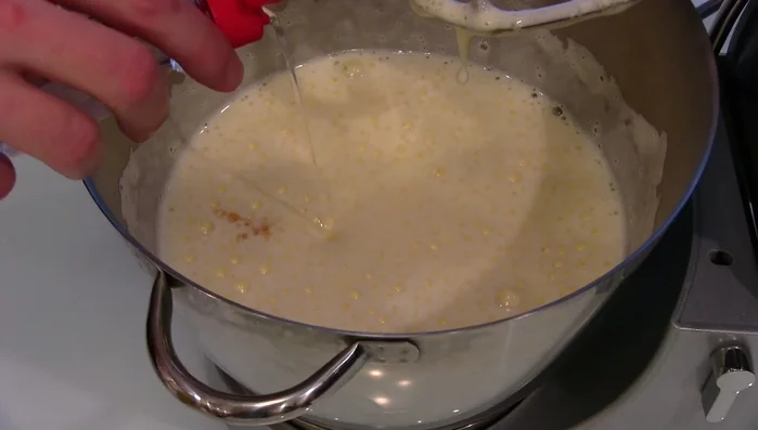 Combine melted butter, vanilla extract, coconut extract, baking powder, and half the flour. Whisk.