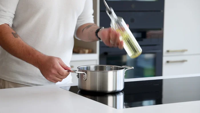 Add oil to a hot pan, then sauté shallots and other vegetables with lime leaves for a minute or two until some color forms.