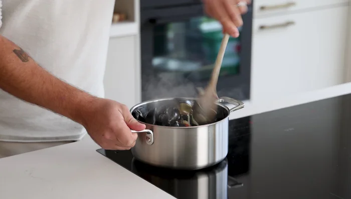 Add mussels and stir-fry for another minute. Deglaze the pan with coconut milk, cover, and boil until mussels open (about a minute).