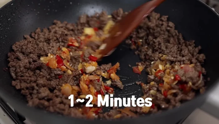 Add the chili-garlic paste and stir-fry for 1-2 minutes over medium-high heat. If needed add more oil.
