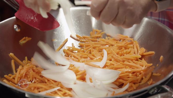 Add sliced onions and stir-fry briefly.