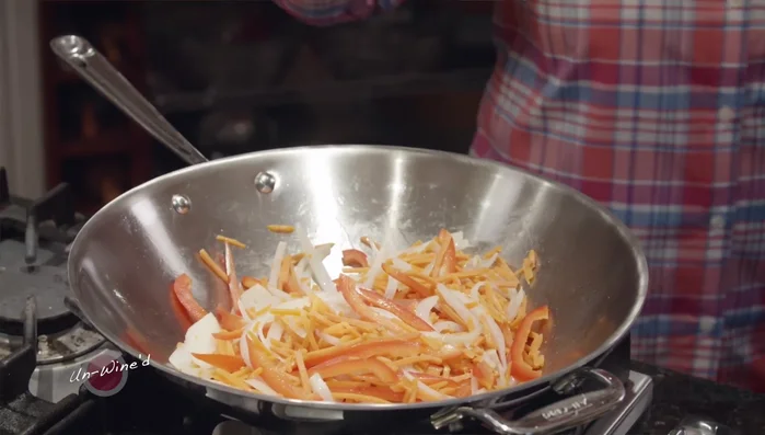 Add herbs (basil, cilantro, Thai basil if available), and green onions to the pan.