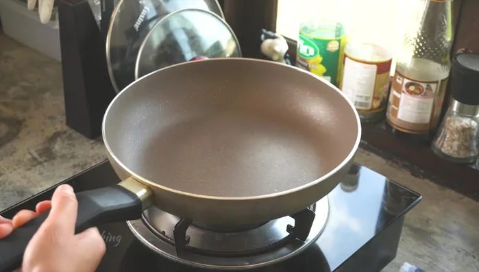 Heat oil in a wok or large pan over medium heat.