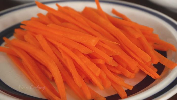 Prepare your ingredients: Chop sweet basil, cucumber, carrot, mint, Thai chili, and garlic.