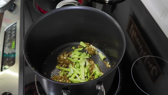 Add broccoli stems, carrot, sweet potato, and bell pepper to the pot. Add water (or broth) and bring to a boil.