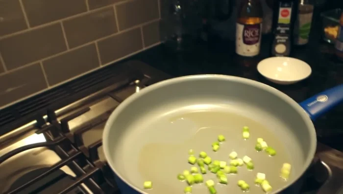 Sauté green onion bottoms, garlic, salt, chili flakes, and red pepper flakes.