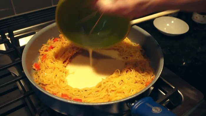 Whisk eggs and add them to the skillet, scrambling gently.