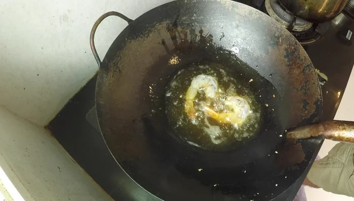 Using the same oil, stir-fry the shrimp until lightly browned and curled. Remove and set aside.