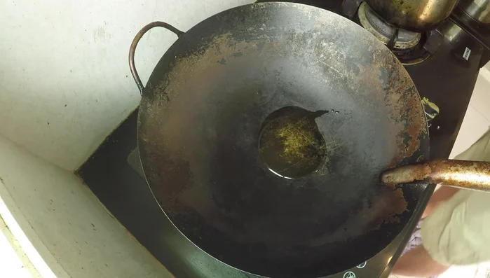 Heat fresh oil in the wok over medium-high heat. Add chilies and stir-fry briefly.