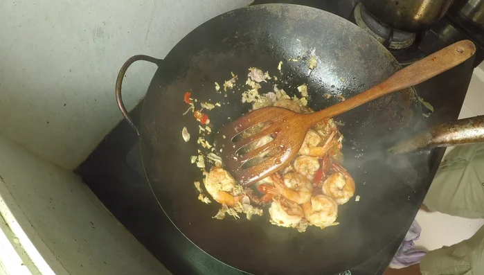 Reduce heat to medium. Add light soy sauce, oyster sauce, and Thai seasoning sauce. Stir-fry briefly. Turn off heat and mix for a few seconds.