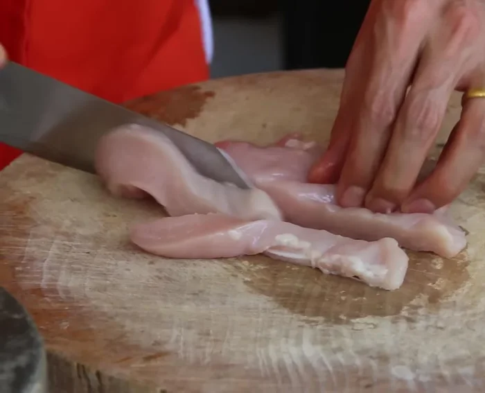Slice the chicken breast into bite-sized pieces.