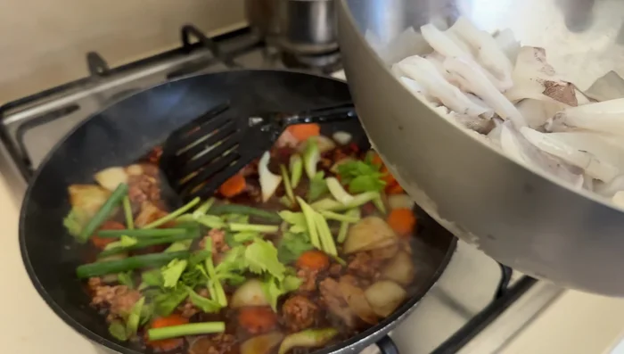 Add the prepared squid; stir-fry until cooked.