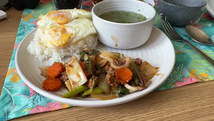 Serve hot with rice and optional Thai soup and eggs.