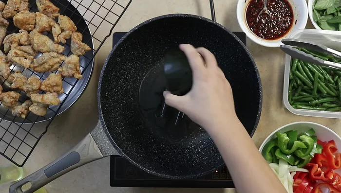 Stir-fry garlic and vegetables in a wok (or pan) with oil for 45 seconds. Add Thai basil.