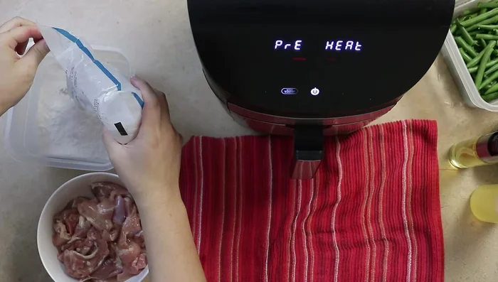 Preheat air fryer to 400°F. Toss chicken in tapioca starch until fully coated.