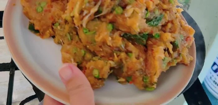 Add the fish cake mixture to the pan and stir-fry until it's dry. If the mixture gets too dry, add a little water.