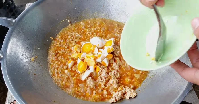 Add salted eggs (3, optionally remove some egg whites). Stir-fry. You can crush the eggs or leave them in pieces.