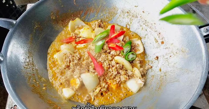 Add green and red chili peppers and chopped spring onions.