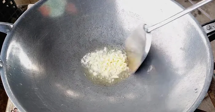 Add minced garlic and stir-fry until yellow and fragrant.