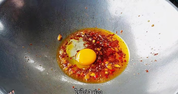 Crack eggs one by one into the pan.