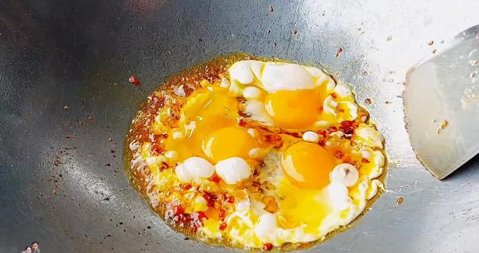 Gently stir the eggs, avoiding crushing the yolks.