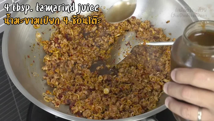 Stir-fry until the pork is about 50-60% cooked. Then add tamarind juice, fish sauce, and palm sugar. Adjust seasoning to taste.