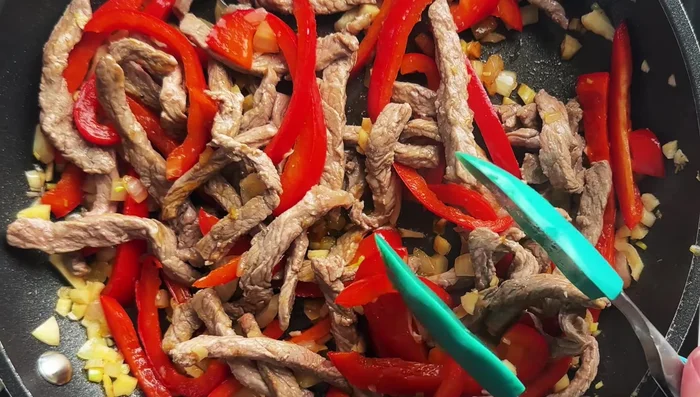 Return beef to the pan. Add soy sauce, brown sweetener (optional), and basil leaves. Stir until basil is wilted.