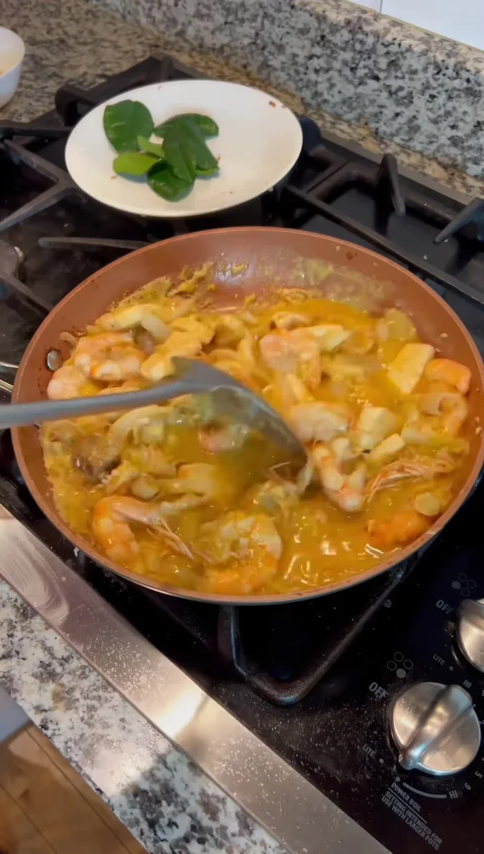 Simmer and finish: Reduce heat and simmer until the sauce thickens and the shrimp and squid are cooked through. Add chili paste (if using).