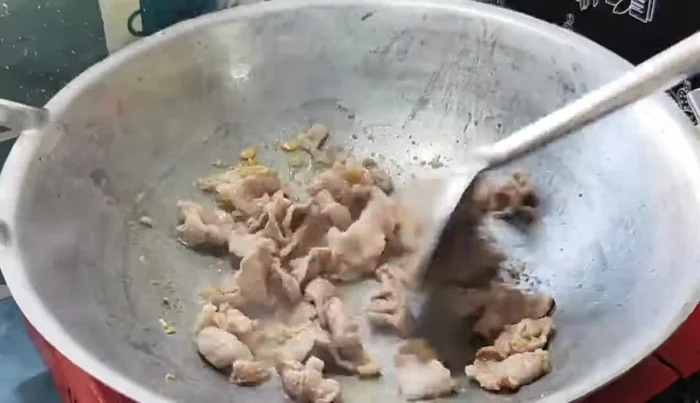 Dissolve shrimp paste in a little water and add it to the pan. Stir-fry to blend the flavors.