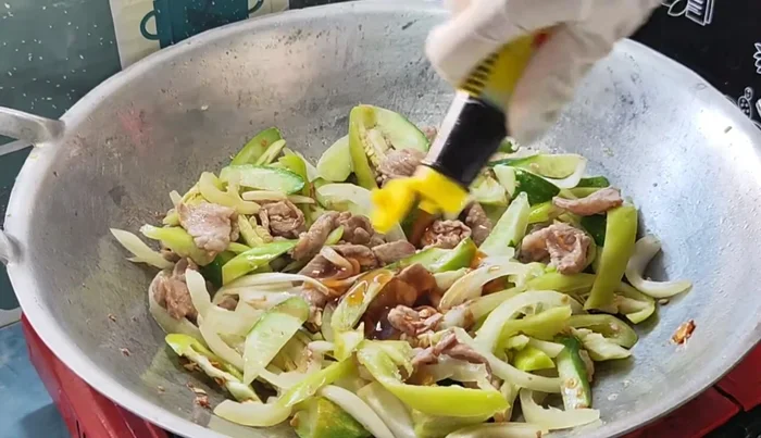 Season with oyster sauce, light soy sauce, and granulated sugar. Stir-fry until well combined. Add more water if needed to prevent dryness.