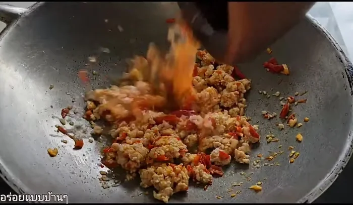 Add water used to rinse the mortar and pestle, and stir-fry until the pork is cooked.