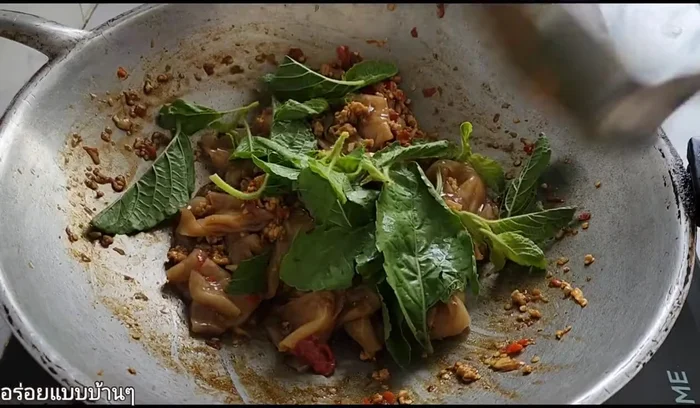 Add the holy basil leaves and stir-fry until wilted and fragrant.