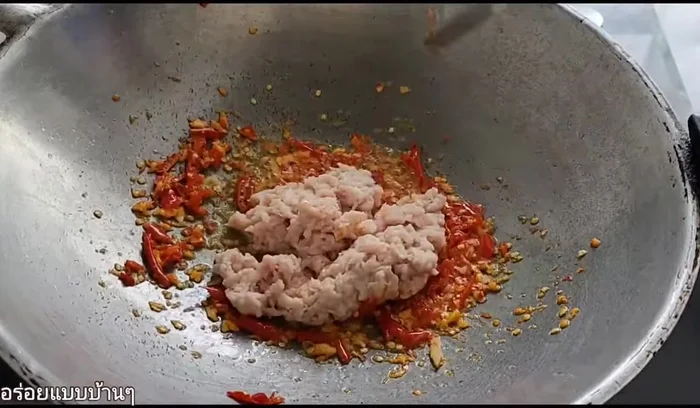 Add the minced pork and continue stir-frying.