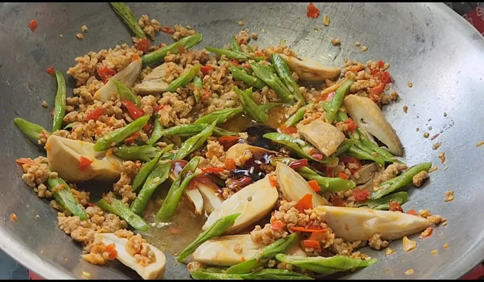 Season with oyster sauce, fish sauce, seasoning sauce, and sugar.