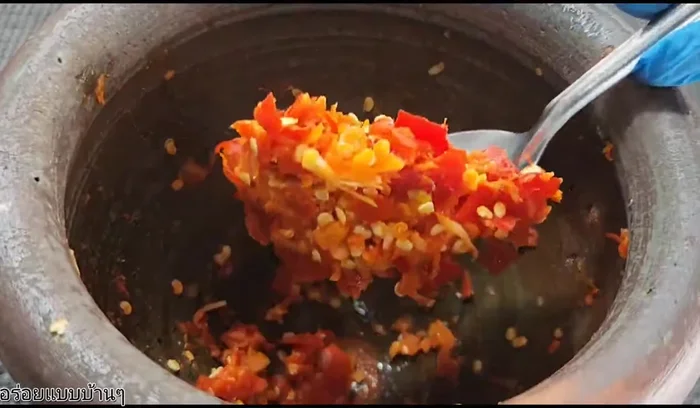 Pound the chilies and garlic.