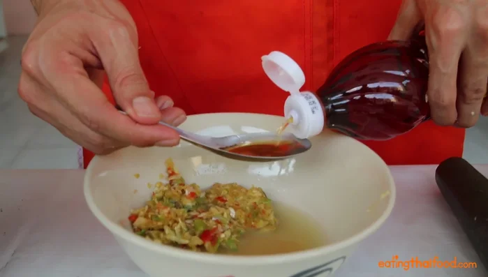 Mix the pounded garlic and chilies with lime juice, fish sauce, sugar, and water to your preferred consistency.