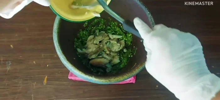 Pound the cooked tilapia meat until fine.